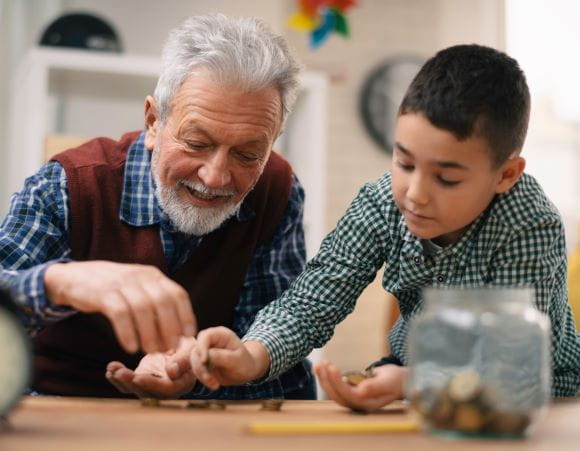 Image of grandpa and grandson counting money