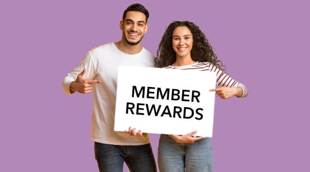 A man and a woman holding the member rewards sign