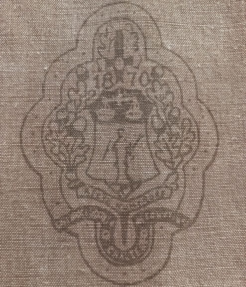 Close up pic of a society badge on a wall hanging