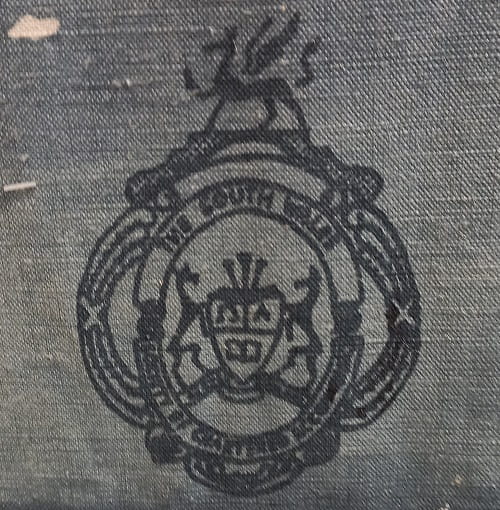 Close up pic of a society badge on a wall hanging