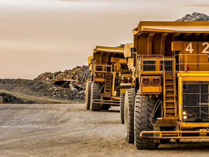 large yellow mining trucks mine trendwatch M&A ICAEW Corporate Financier