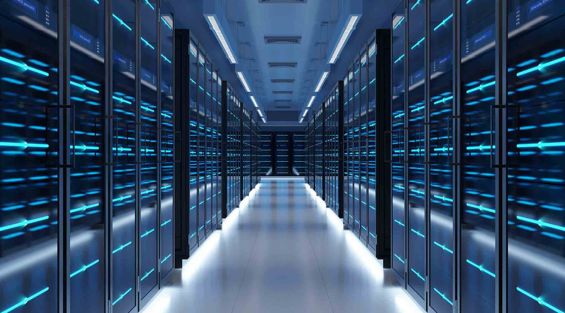 a long row of computer servers room blue lights behind glass doors