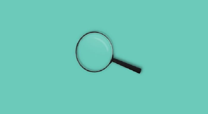 Magnifying glass on teal background